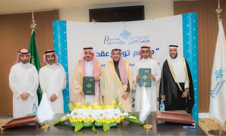 ستة رجال توقفوا عن الملابس السعودية التقليدية، من ضمنها الغترة أو الشماغات والعقال والبشتت صورة السعودي، للتواصل مع الأطفال، من خلال مراسم توقيع في جامعة القصيم، وذلك أمام لافتة وطاولة تحمل الزهور والوثائق الرسمية، إيذاناً لبناء جديدة الدماغ العقلي.