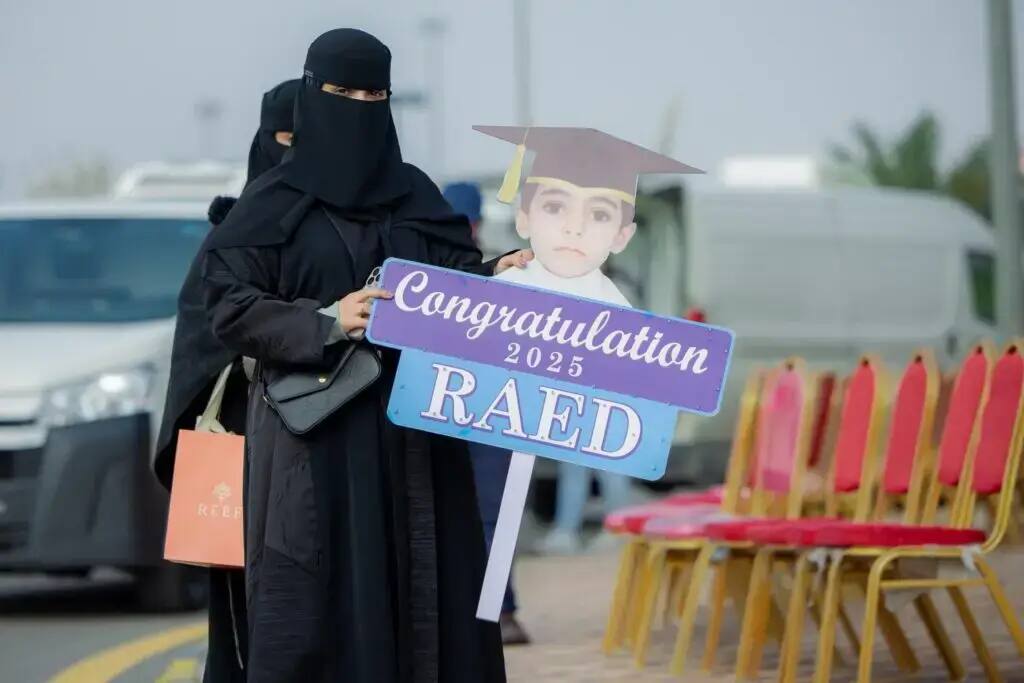 A women's sweater with the image of a child holding a woman's graduation cap, along with the words: "Congratulations 2025 Pioneer, Graduate". Different colors for some vehicles.