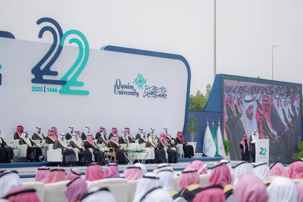 A photo from the graduation ceremony at Qassim University shows the emir of Qassim Province sitting on the main stage. The absence of guests and attendees in the Saudi shemagh or Saudi ghutra at the beginning of the ceremony is majestic. A large screen behind the podium was taken to highlight a person giving a speech on the podium, with the university logo and the number "22" in an official private background.