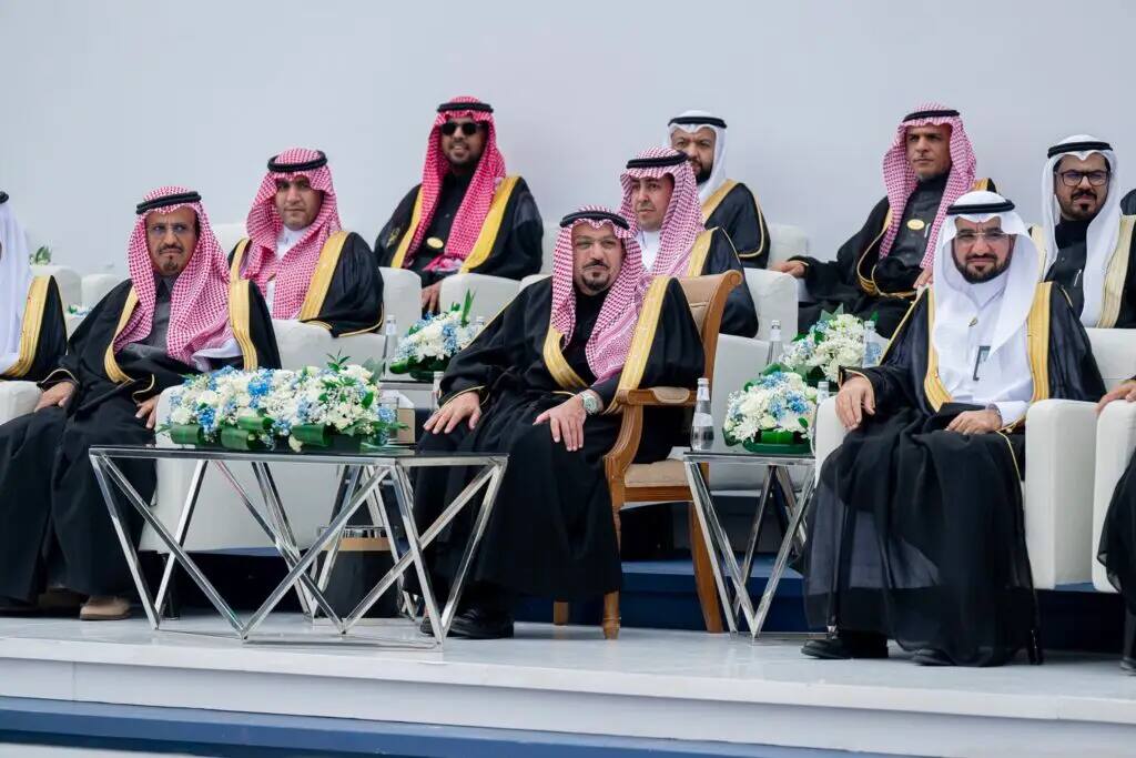 A group of men dressed in the official Saudi uniform, which includes the black abda, complete with gold embroidery, and the red and white Saudi shemagh or tunic, sat in the Holy Book of Qassim, with His Highness the Emir of Qassim Region among the graduates. Tables were decorated for the event, adding a touch of glamor and grandeur.