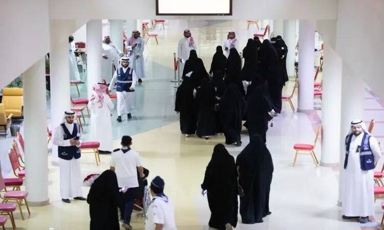 مجموعة من الرجال، من بينهم طلاب الدفعة التاسعة والتسعة من جامعة القصيم، وسيشونون في ردهة ذات أعمدة طويلة وكراسٍ حمراء من خلال إحدى فرق التحرير الرسمية. وقد ارتدى عددٌ من الرجال الزي السعودي التقليدي التوسع في الغترة أو الشماغ السعودي مع عقال وبشت سعودي، الأمر الذي أضافى على البرنامج الرسمي والاحتفالي المميز.