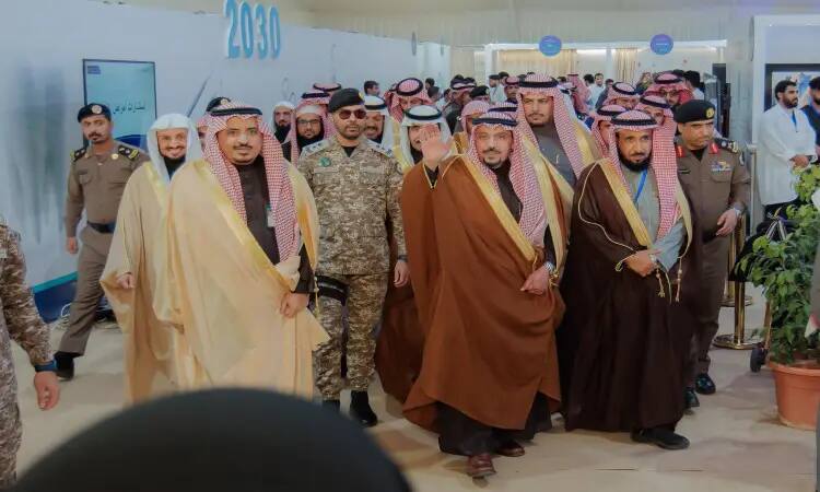 A group of Saudi men celebrating in traditional clothes, Saudi bishut, as well as shemaghs or ghattar and aql. On the right side is a plant planted in Asil, and on the left side is a plant plant planted in Asil, with "2030" in the background.