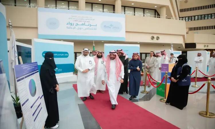 A group of men dressed in Saudi Arabia's Ghutrah or Shemagh, Eqbal and Bishtet walk the red carpet through the riches of their public wealth, with a princess and a black niqab nearby. Think in the background of signs from the Deanship of Personnel Affairs promising notices with Arabic texts.