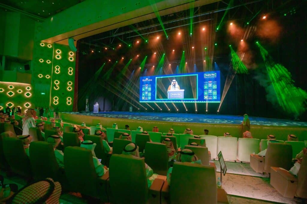 An academic celebration at Qassim University on the occasion of the 95th National Day amid heavy attendance and green lighting.