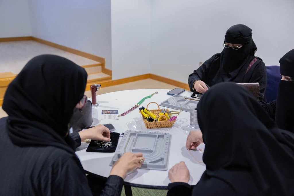 Qassim University's handicraft workshop brings together members to make traditional jewelry.