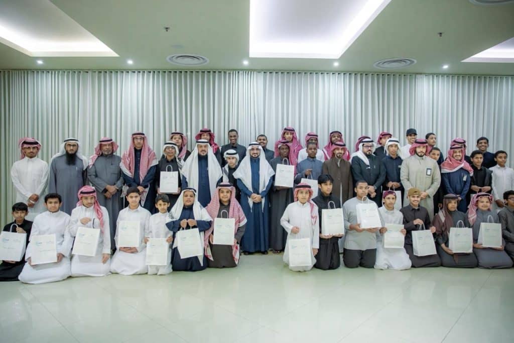 Students and orphans at a Ramadan Iftar event at Qassim University under academic supervision.