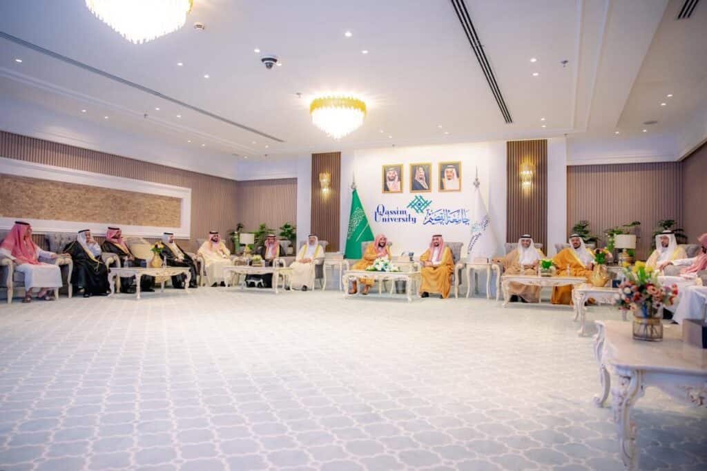 A formal meeting at Qassim University within an academic framework, reflecting Saudi Islamic identity.