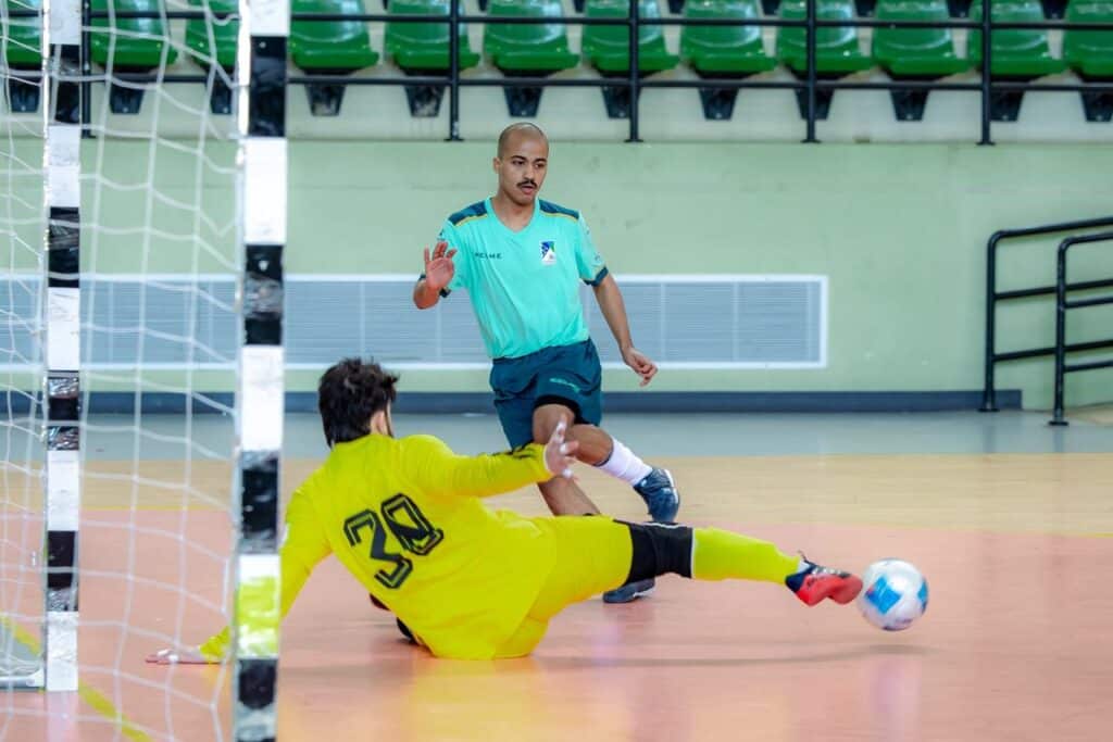 Futsal goalkeeper blocking a shot during the universities championship at Qassim University in the Kingdom.