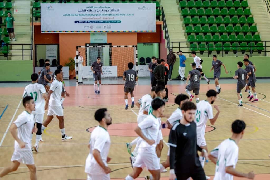 Handball match at Qassim University as part of the Saudi Federation Championship, attended by students and faculty members.