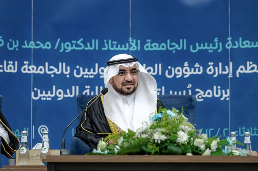 An official from Qassim University speaks at an academic conference about university affairs.