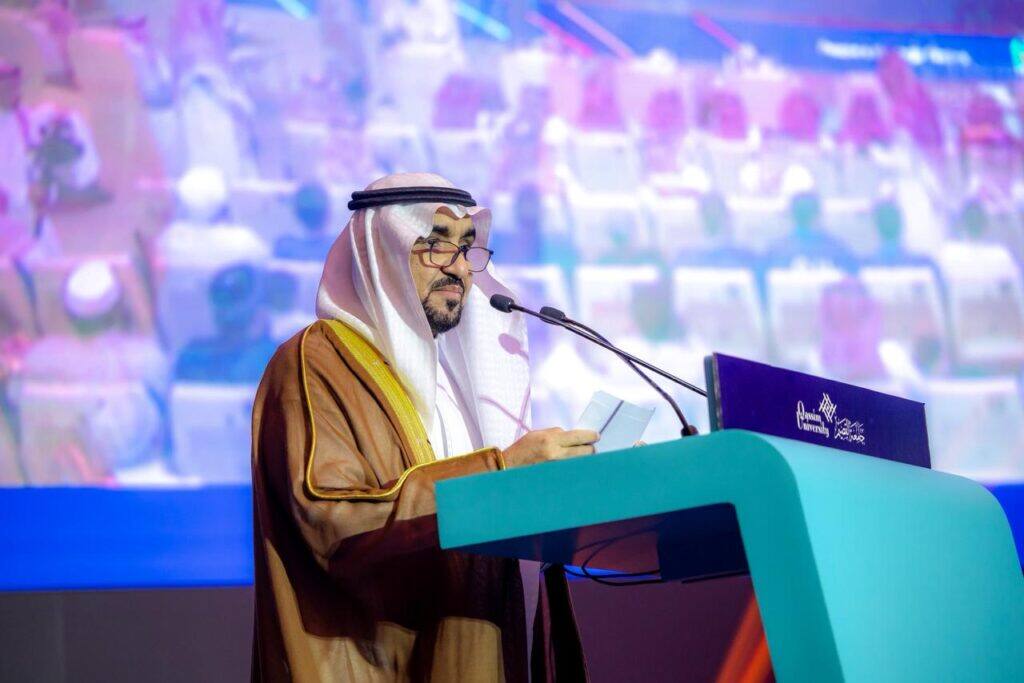 Delivering a formal speech during the Peoples' Heritage Festival at Qassim University in the presence of university staff.