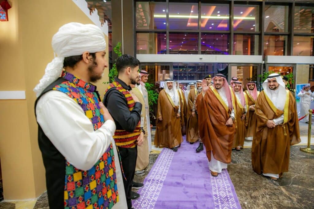 Official reception for Qassim University students at the Festival of Peoples inside a decorated hall.
