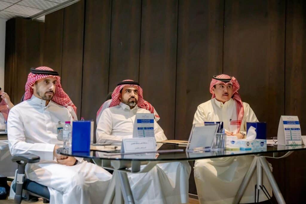 An academic meeting within the intensive training program at Qassim University in a formal organizational environment.