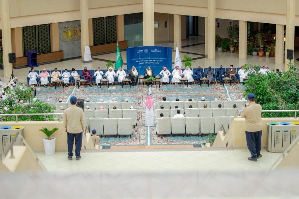 Qassim University's academic event, attended by university officials and international students, took place in a distinguished hall.
