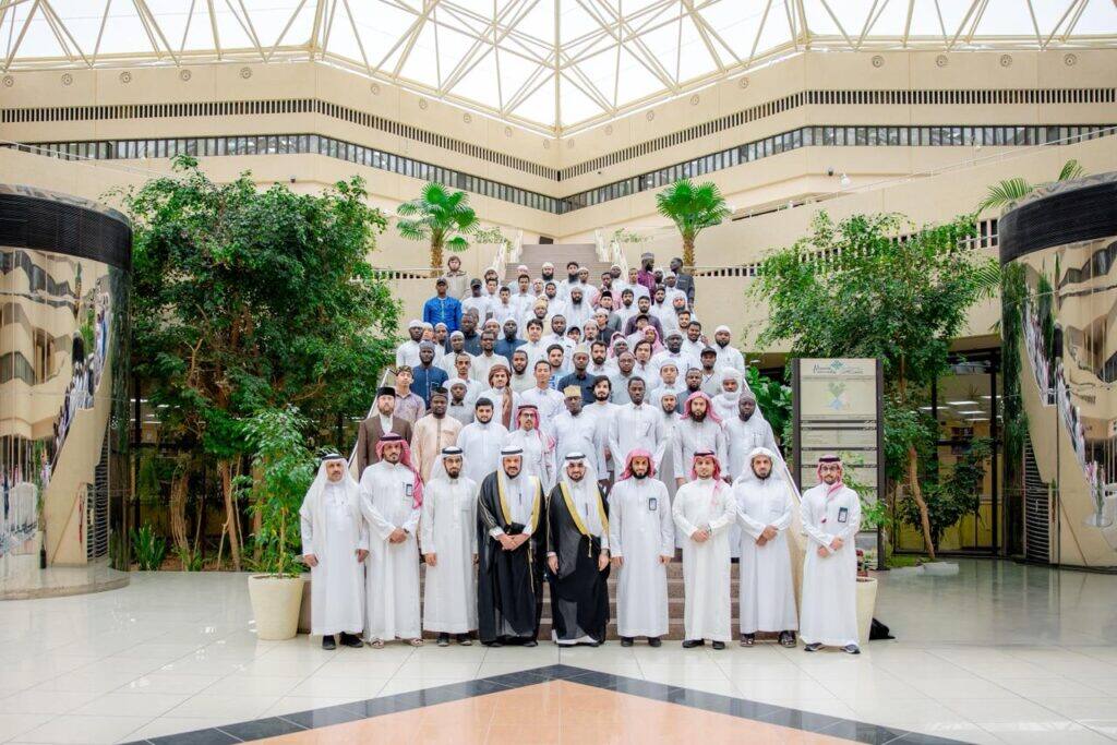 A formal academic event at Qassim University about the "Yesser" program, attended by speakers and faculty members.